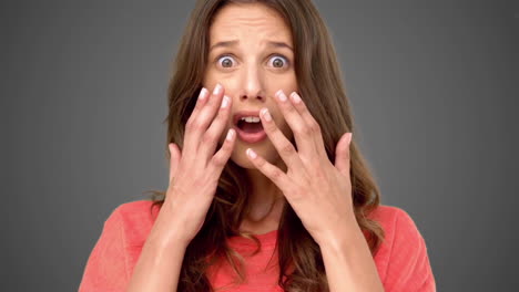 Woman-cowering-with-fear-on-grey-background