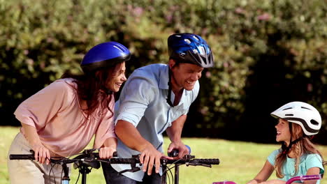 Parents-and-children-pointing-the-way-to-go-while-they-are-riding-bicycle