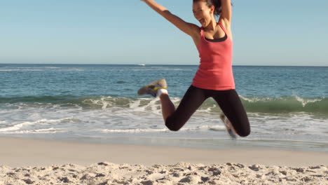 Woman-running-and-jumping-on-the-beach
