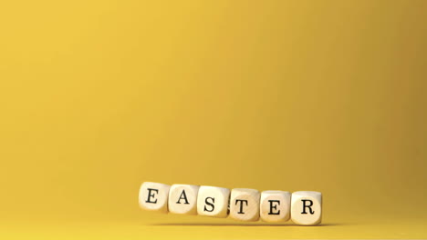 Dice-spelling-out-easter-falling-against-yellow-background