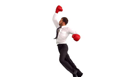 Businessman-in-boxing-gloves-jumping-and-punching-air