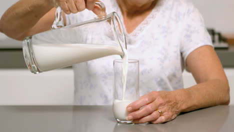 Woman-pouring-glass-of-milk
