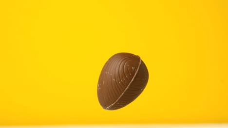 Easter-egg-falling-against-yellow-background