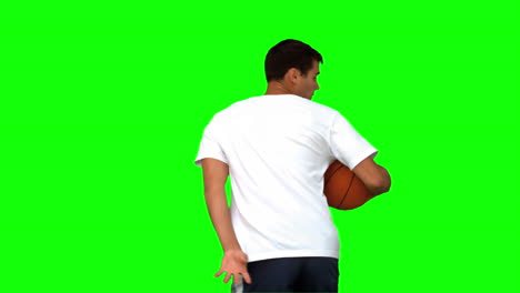 Man-dribbling-with-a-basketball-on-green-screen