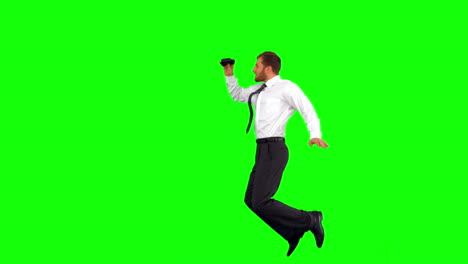 Businessman-looking-through-binoculars-while-leaping