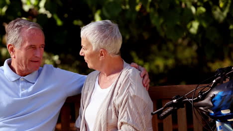 Elderly-couple-sitting-on-a-bench-park