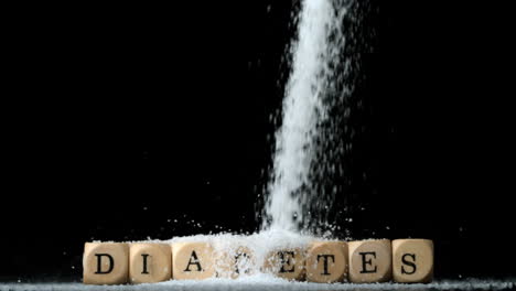 Sugar-powder-being-poured-over-dice-spelling-out-diabetes