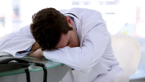 Young-doctor-sleeping-on-a-desk