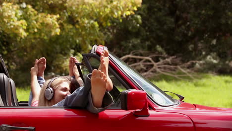 Girls-listening-to-music-in-a-red-car