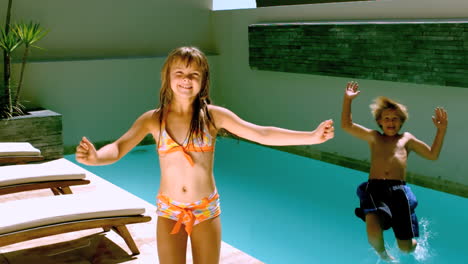 Young-girl-dancing-while-brother-jumping-in-the-swimming-pool