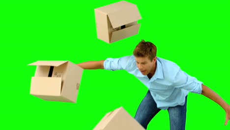 Clumsy-man-dropping-boxes-over-on-green-screen