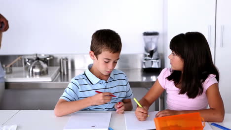 Parents-standing-next-to-children-doing-their-homework-