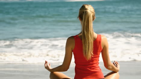 Woman-meditating-on-the-beach