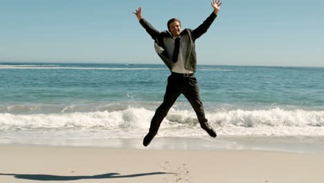 Attractive-businessman-jumping-on-the-beach