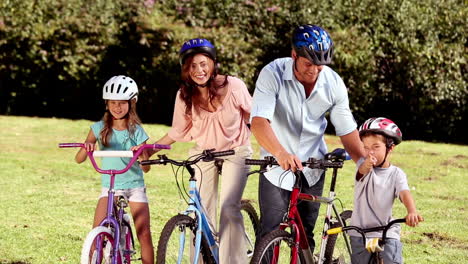 Parents-showing-the-direction-to-children-while-they-are-riding-bicycle