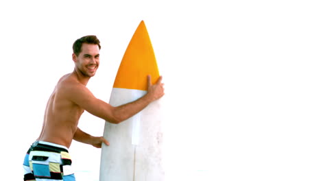 Man-next-to-a-surfboard-looking-at-the-camera