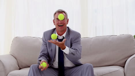 Businessman-playing-with-tennis-ball