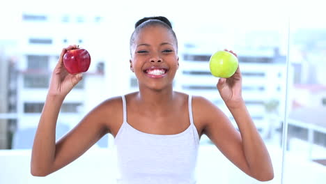 Cheerful-beautiful-model-holding-apples