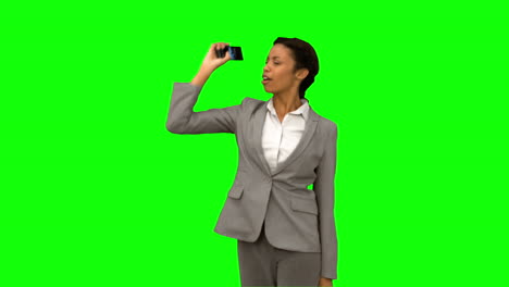 Angry-woman-raising-her-phone-in-the-air-on-green-screen