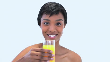 Attractive-woman-holding-a-glass-of-orange-juice-