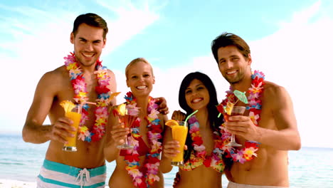 Friends-wearing-garlands-and-enjoying-cocktails-on-the-beach