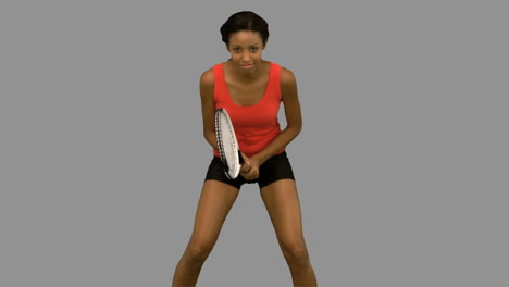Woman-playing-tennis-on-grey-screen