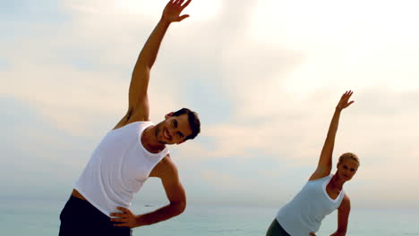 Friends-in-stretching-together-on-the-beach