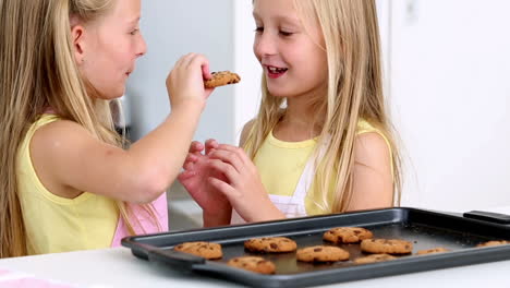 Sisters-feeding-each-other-fresh-cookies