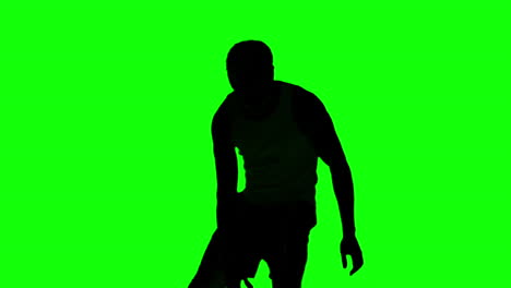 Silhouette-Eines-Mannes,-Der-Auf-Einem-Greenscreen-Basketball-Spielt