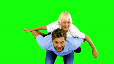 Son-having-a-piggy-back-on-his-father-on-green-screen