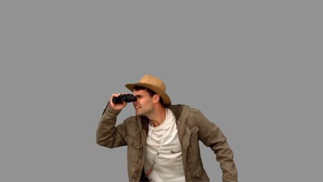 Man-jumping-and-using-binoculars-on-grey-screen-