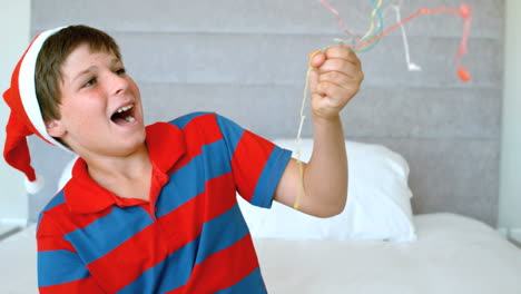 Happy-boy-using-party-popper-in-the-bedroom