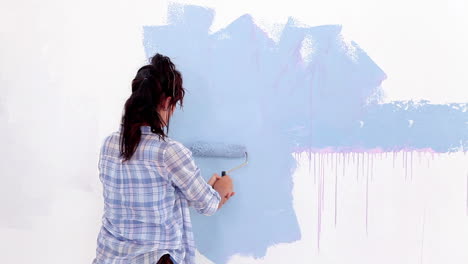 Attractive-woman-painting-her-wall