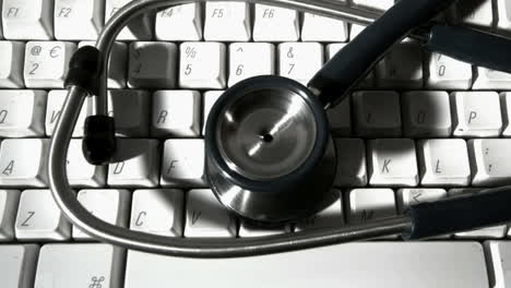 Stethoscope-falling-and-bouncing-onto-computer-keyboard-