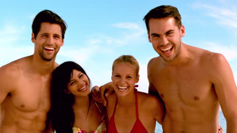 Friends-laughing-to-the-camera-at-the-beach