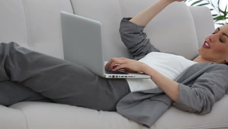 Businesswoman-working-lying-down-on-a-sofa