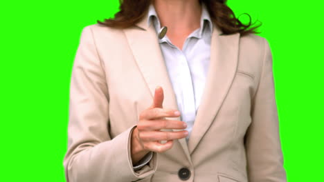 Pretty-businesswoman-throwing-a-coin-on-green-screen