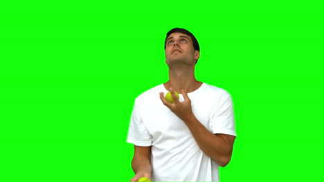 Handsome-man-dribbling-with-balls-on-green-screen