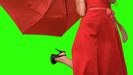 Woman-in-high-heels-holding-a-broken-umbrella-on-green-screen