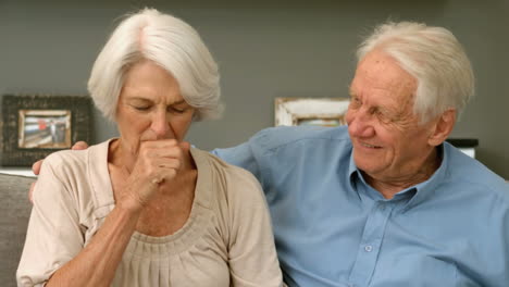 Old-woman-coughing-next-to-her-husband