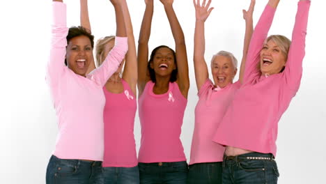 Group-of-cheerful-women-raising-arms-for-breast-cancer-awareness