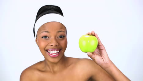 Cheerful-woman-holding-apple