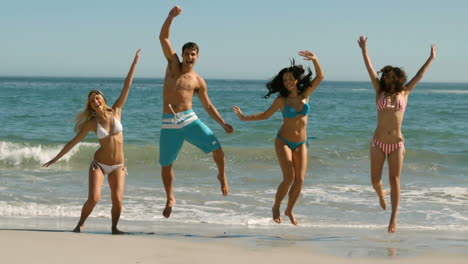 Young-cheerful-people-jumping-at-the-beach