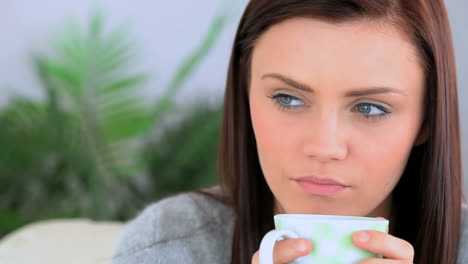 Brunette-woman-holding-a-cup-of-coffee