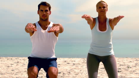 Friends-doing-pilates-on-the-beach-together