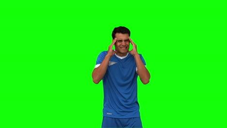 Football-player-suffering-from-headache-on-green-screen