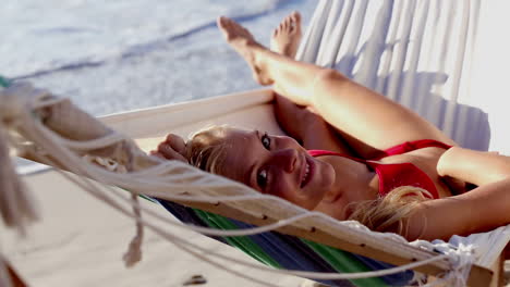 Attractive-woman-in-red-bikini-in-a-hammock