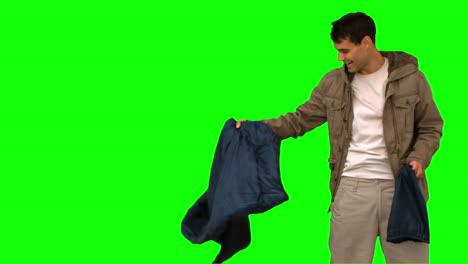 Man-rolling-out-his-sleeping-bag-on-green-screen
