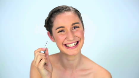 Young-woman-using-tweezers-