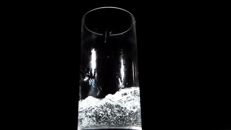 Water-being-poured-on-black-background-